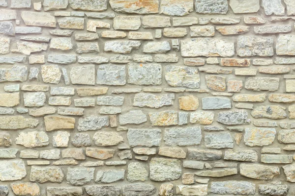 Muro de piedra de color amarillo sólido y beige. Fondo de piedra. — Foto de Stock