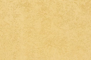 Bej alçılı duvar dokusu. Kusursuz bir yüzey ve soyut katı bir zemin. Soluk boyalı duvar yapısı