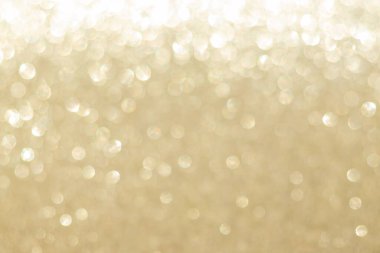 Abstract golden bokeh background, defocused blurry sparkles