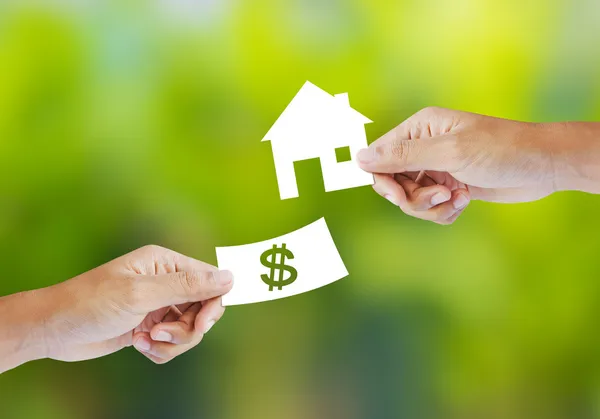 Hand with paper money and house shape — Stock Photo, Image