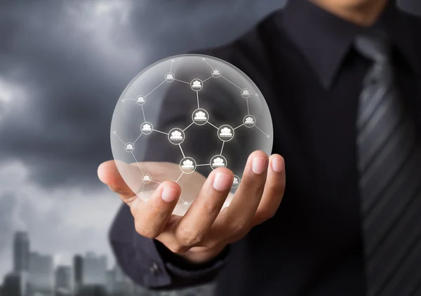 Business people holding social network in crystal ball — Stock Photo, Image