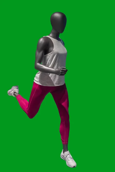 緑の背景に隔離されたスポーツウェアを身に着けているランニング女性ディスプレイマネキンの完全な長さの画像 — ストック写真