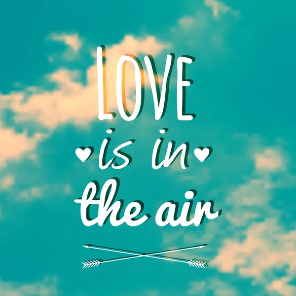 Vector blurred illustration with clouds, sky and text "Love is in the air" — Stock Vector