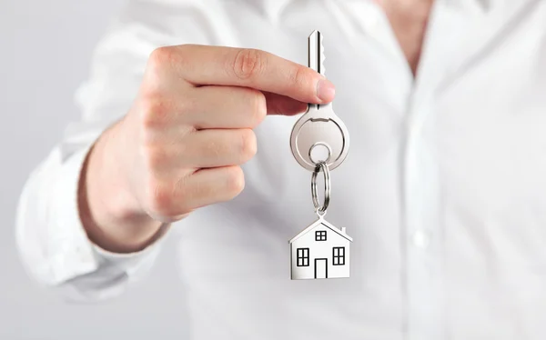 Businessman holding key — Stock Photo, Image