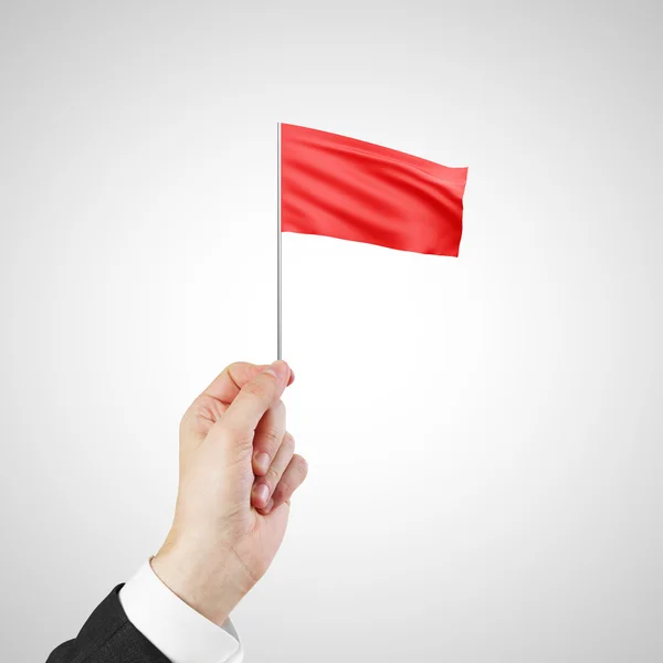 Mão acenando uma bandeira vermelha — Fotografia de Stock