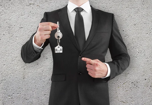 Businessman holding a key — Stock Photo, Image