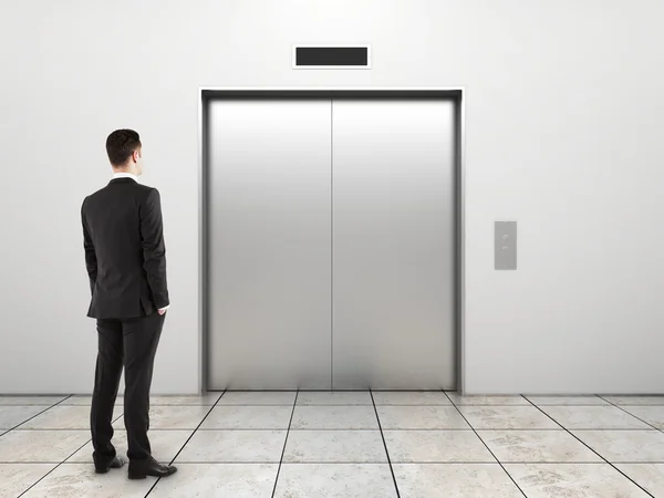 Businessman and elevator — Stock Photo, Image