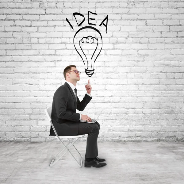 Businessman pointing to lightbulb — Stock Photo, Image