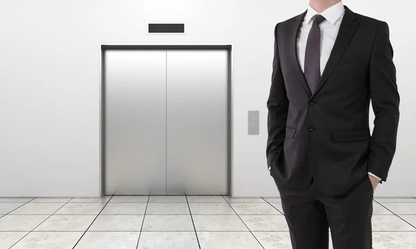 Businessman and modern elevator — Stock Photo, Image