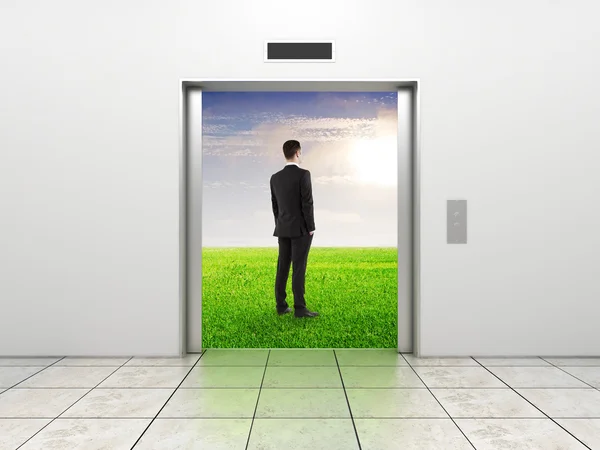 Бизнесмен и современный лифт — стоковое фото