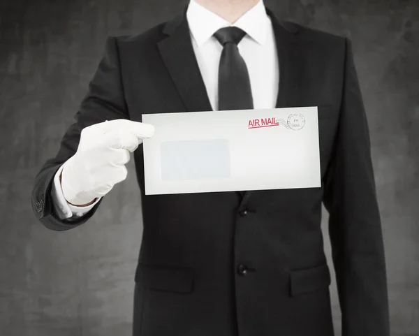 Businessman giving a envelope — Stock Photo, Image
