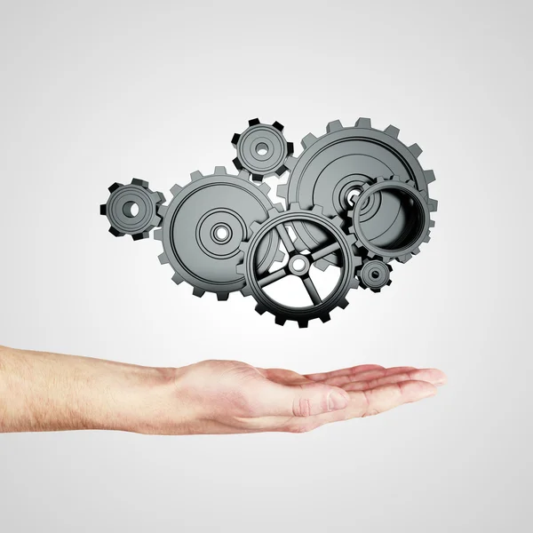 Hand holding gears — Stock Photo, Image