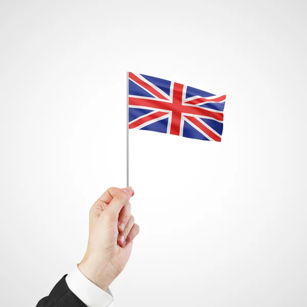Main tenant le drapeau de Royaume-Uni — Photo