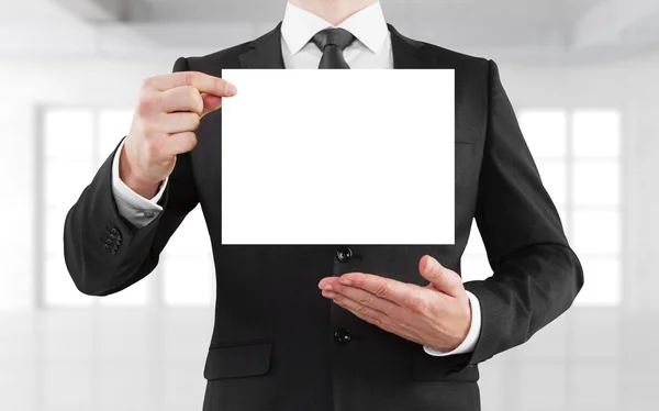 Businessman holding blank poster — Stock Photo, Image