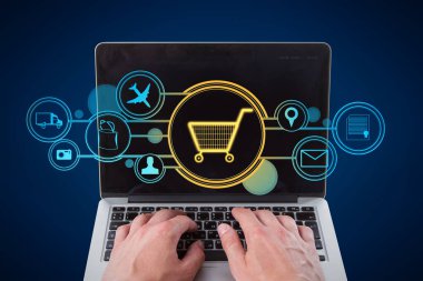Close up of businessman hands using laptop with abstract glowing cart interface on blue background. Online shopping and e-commerce concept. Double exposure