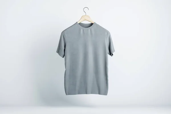 空のグレーのTシャツは 光を背景にテキストのコピースペースで空中にぶら下がります 3Dレンダリング モックアップ — ストック写真