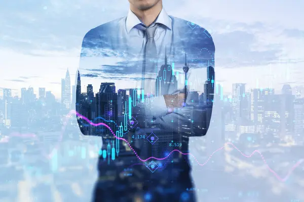 Attractive young european businessman with folded arms standing on abstract blue city background with index, candlestick forex chart and mock up place. Success, fintech, transform and trade concept. Double exposure
