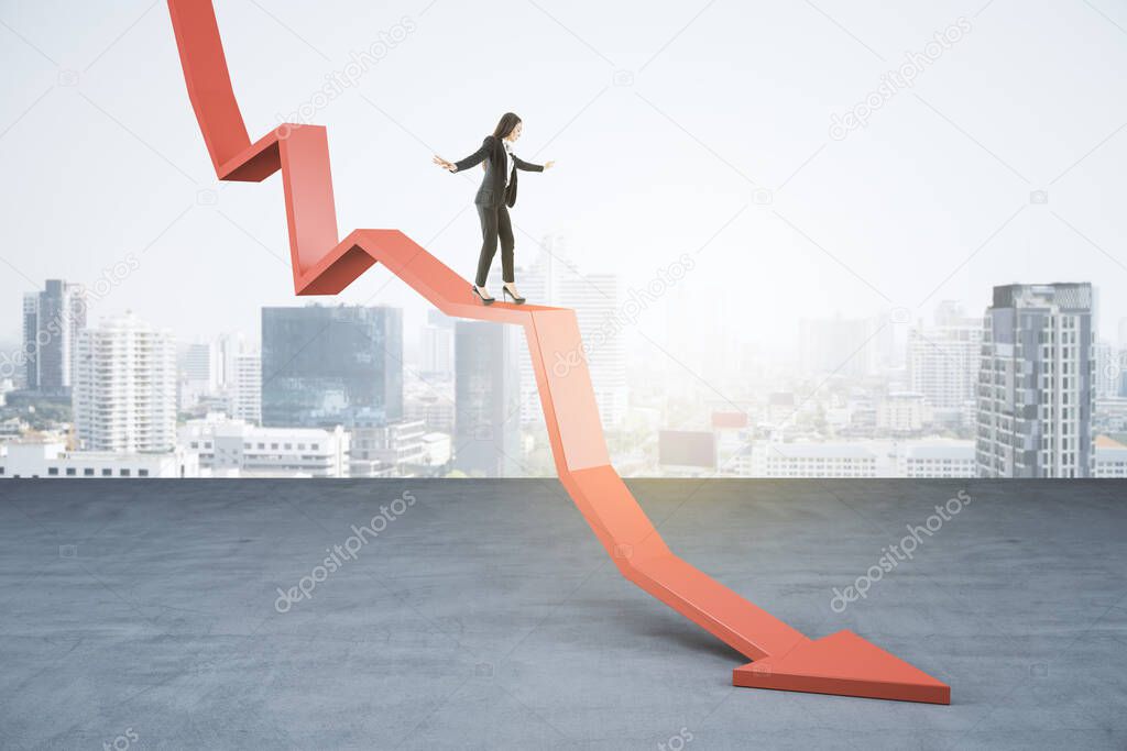 Young businesswoman balancing on abstract falling red arrow on light city background with mock up place. Crisis, economy and work concept