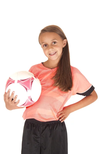 Cute girl holding soccer ball on hips in pink jersey — Stock Photo, Image