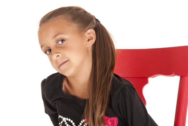 Cute young brunette girl glancing sideways sitting in rocker — Stock Photo, Image