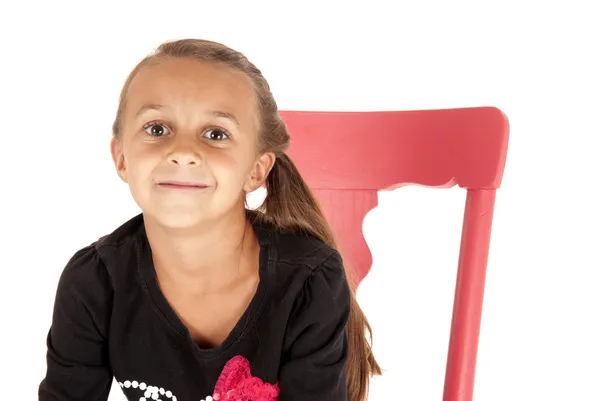 Girl in pink chair close up with a cheesy grin — Stock Photo, Image