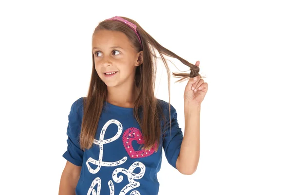 Girl in blue top playing with her hair — Stock Photo, Image
