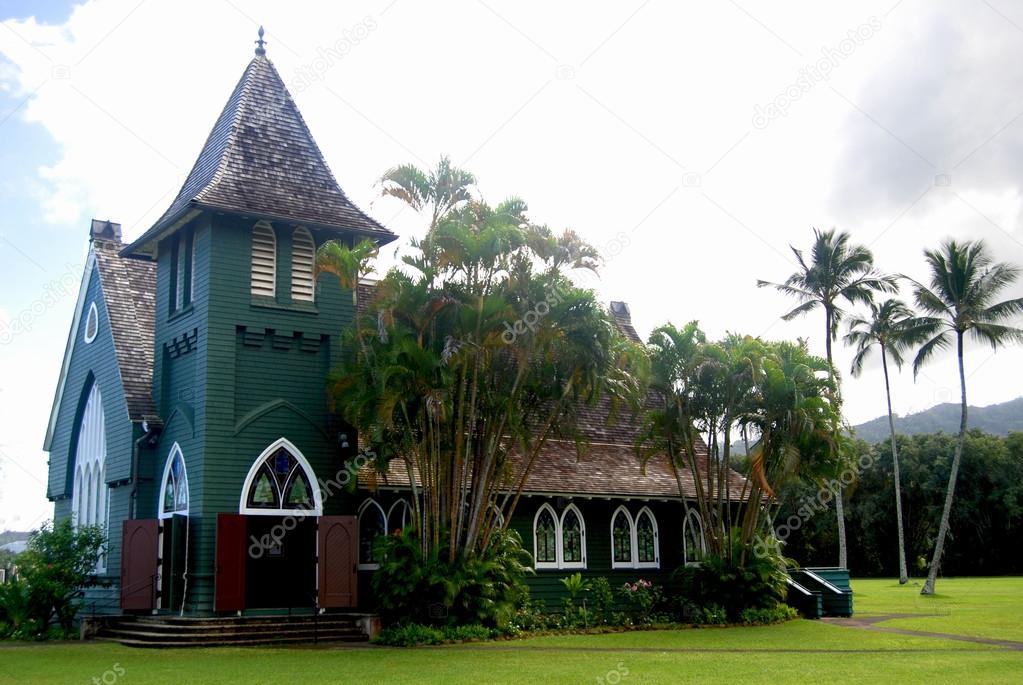 Chapel in Kauai Hawaii with coconut trees and cloudy sky