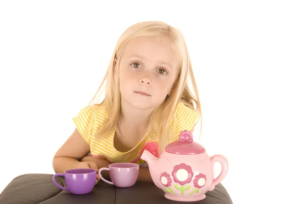 Young blonde girl having a tea party in yellow blouse — Stock Photo, Image