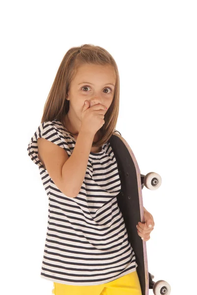 Young girl holding a pink skateboard hand over mouth — Stock Photo, Image