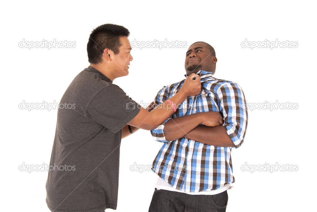 Brother grabs his brother by shirt collar Stock Photo by ©sixdays24
