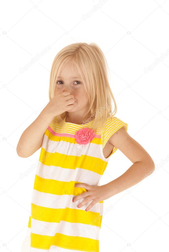 Young girl holding her nose keeping from a stinky smell funny Stock