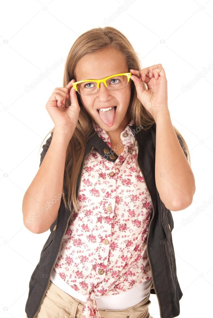 Young female model with yellow glasses sticking her tongue out