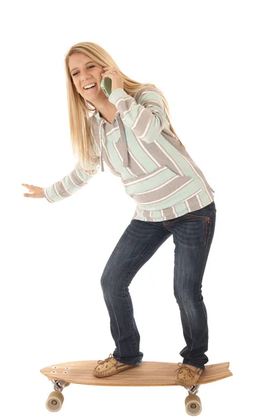 Woman balancing a long board talking on phone — Stock Photo, Image