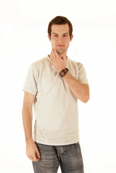 Casual dressed young man standing scratching his chin — Stock Photo, Image