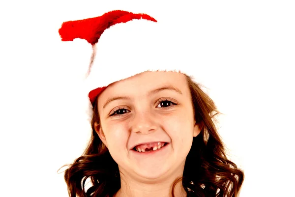 Girl missing her two front teeth wearing santa hat — Stock Photo, Image