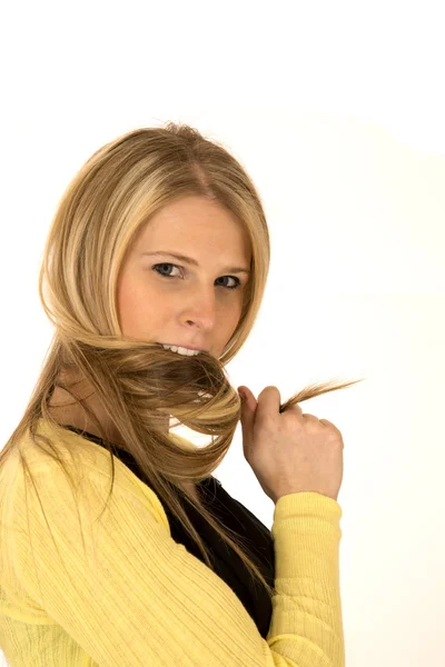 Pretty blonde female biting her twisted hair — Stock Photo, Image