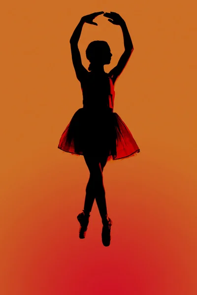 Silhouettr of a young balerina with an orange background — Stock Photo, Image