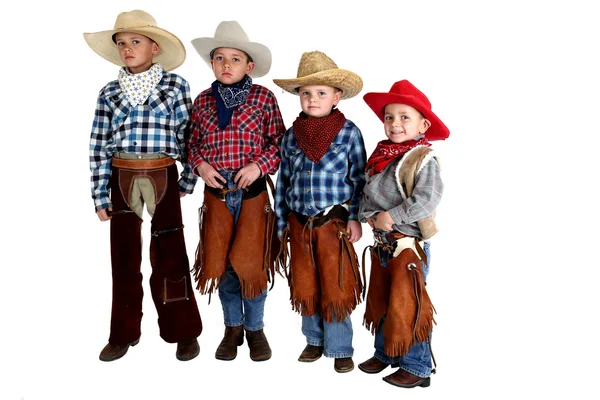 Four cowboy brothers standing wearing hats and chaps — Stock Photo, Image