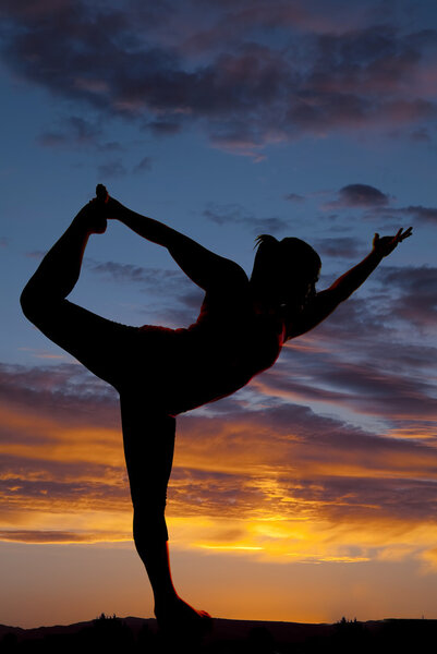 beautiful silhouette of female model in yoga pose