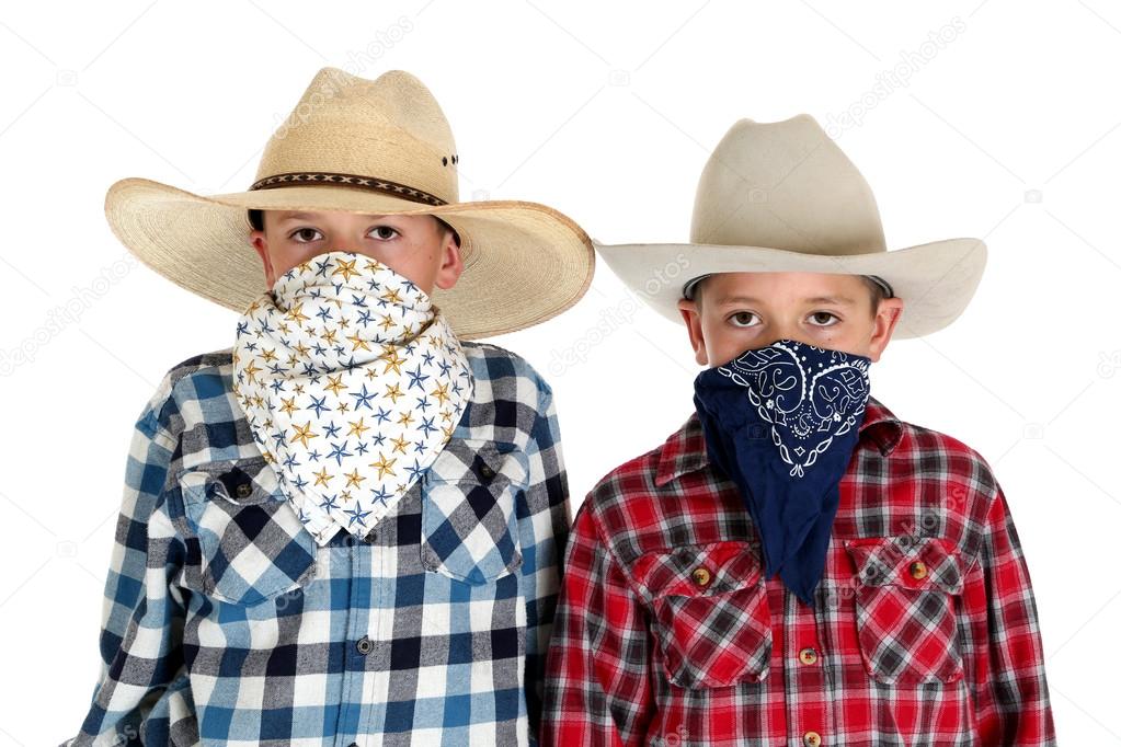 two cowboy brothers wearing hats and bandanas looking at camera