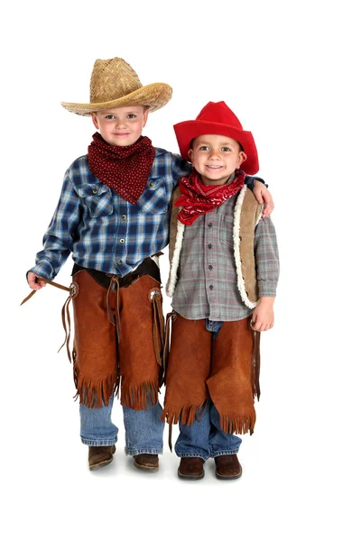 Dos hermanos sonriendo abrazándose en trajes de vaquero — Foto de Stock