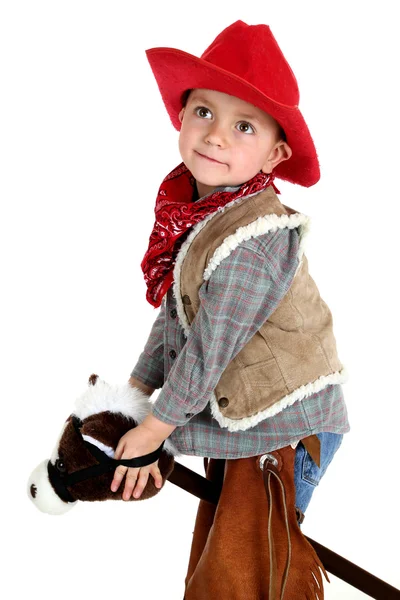 Bonito jovem cowboy equitação brinquedo vara cavalo — Fotografia de Stock