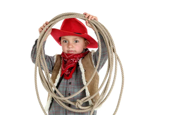 Ung cowboy bär en snusnäsduk spelar med ett rep — Stockfoto