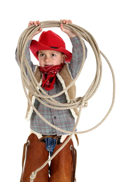 Rapaz brincalhão em roupa de cowboy segurando corda usando chaps — Fotografia de Stock