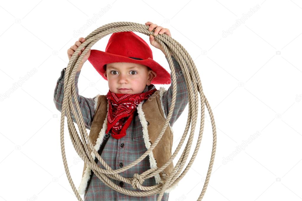 young cowboy wearing a bandanna playing with a rope