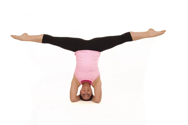 Female model doing yoga open angle pose in headstand splits — Stock Photo, Image