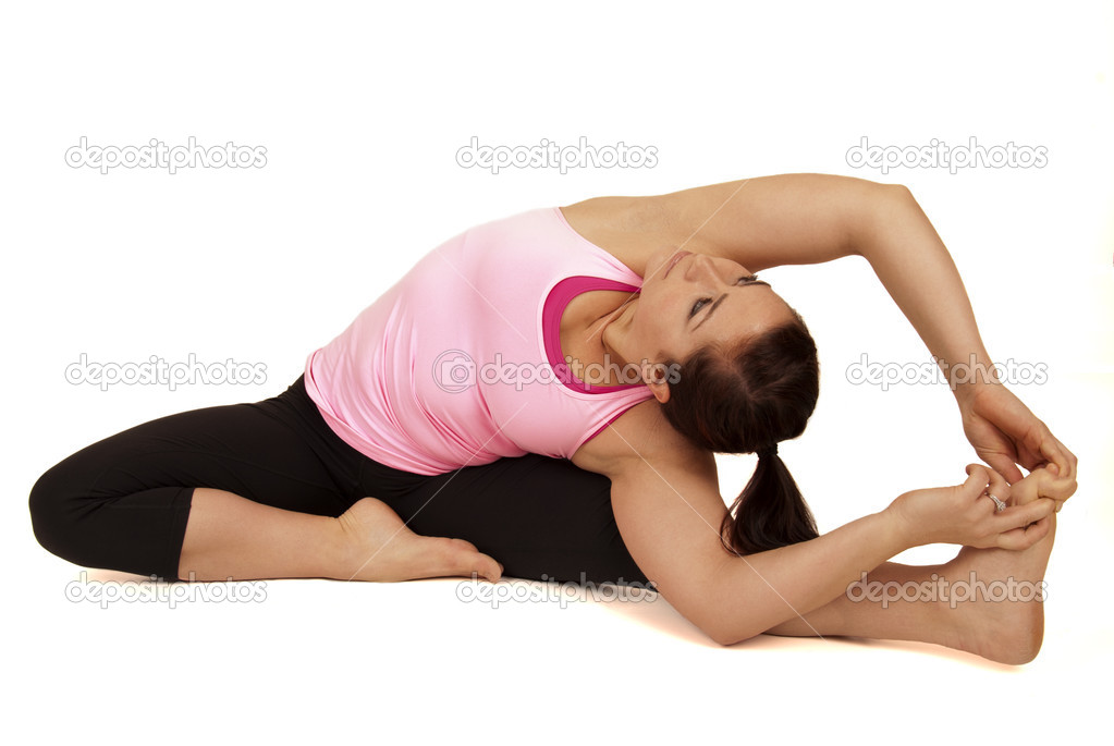 Yoga instructor in seated side stretch pose Parsva Upavista Kona