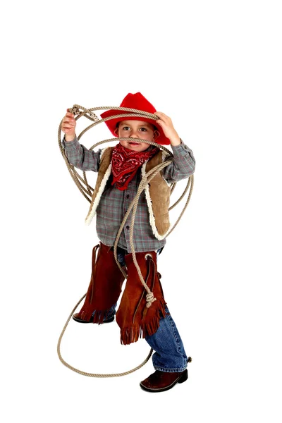 Adorable joven vaquero con chaparreras, botas y sombrero jugando con — Foto de Stock