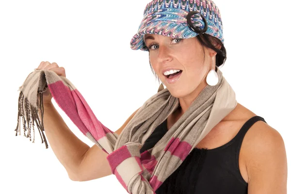 Cute brunette female holding striped scarf wearing knit hat — Stock Photo, Image