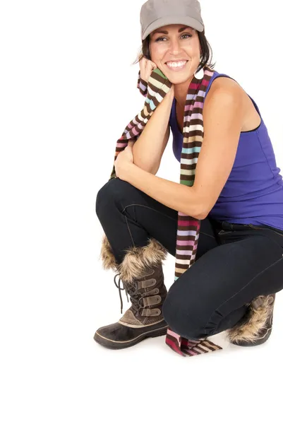 Beautiful brunette smiling crouched down on knees wearing boots — Stock Photo, Image